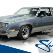 1984 Blue/Silver Oldsmobile Cutlass thumbnail