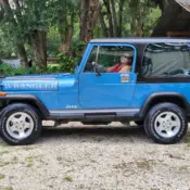 1987 Blue Jeep Wrangler thumbnail