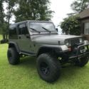 1992 green/gray Jeep Wrangler thumbnail